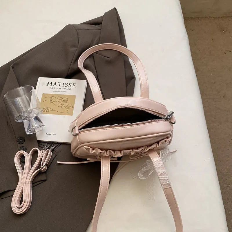 Women's casual PU bandage bow shoulder handbag with visible stitching, shown in milky white colour.