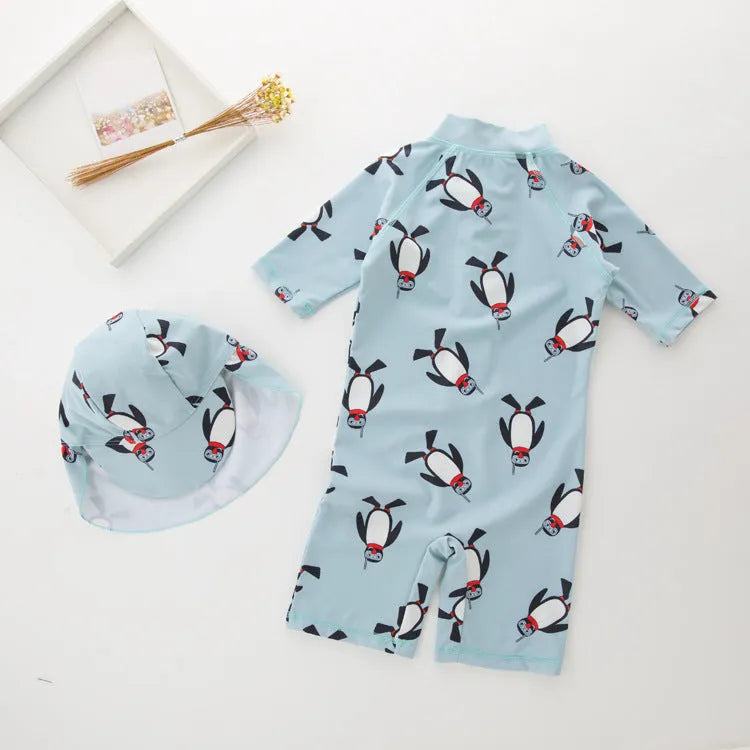 Boys' long sleeve penguin print swimsuit set with matching swim cap for sun protection.