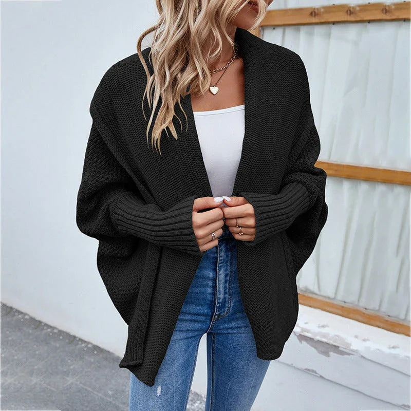 A cozy, oversized knit cardigan with a unique bat-wing sleeve design and large lapel, available in a variety of stylish colors.