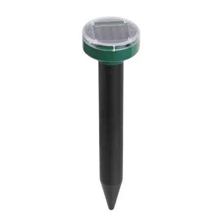 Solar ultrasonic mouse repeller with black solar panel and battery unit on grassy ground