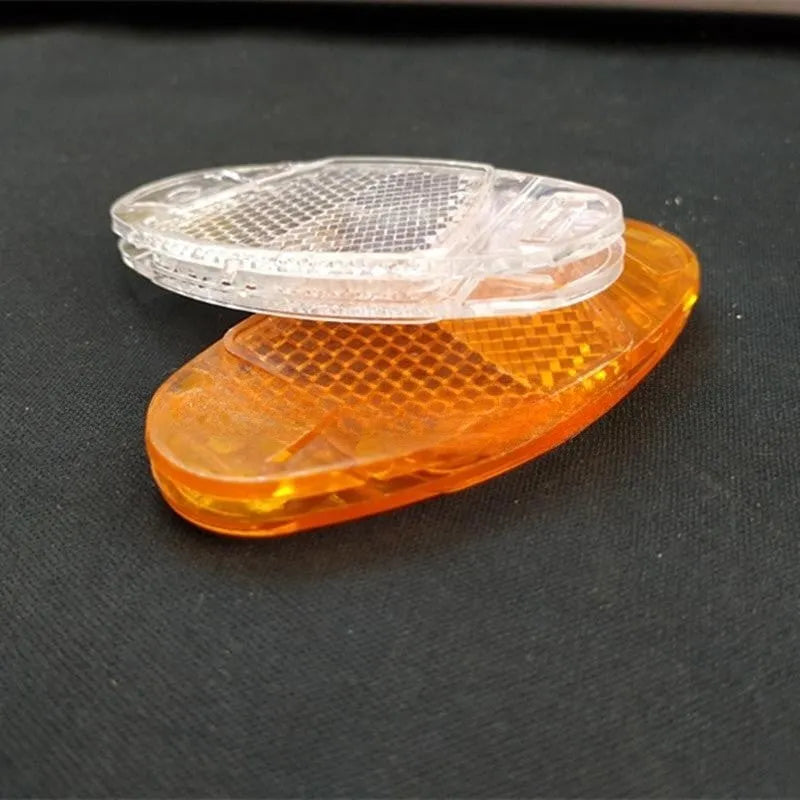 White and yellow plastic bicycle spoke reflector for wheel safety, dimensions 7.2cm long by 3.5cm wide.