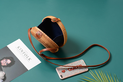 A collection of hand-woven tropical straw purses in various shapes, sizes, and designs, perfect for Kiwi summer style.