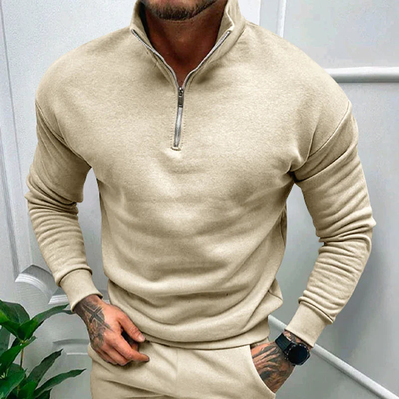 A man wearing a comfortable, fleece-lined long sleeve pullover in a solid color.