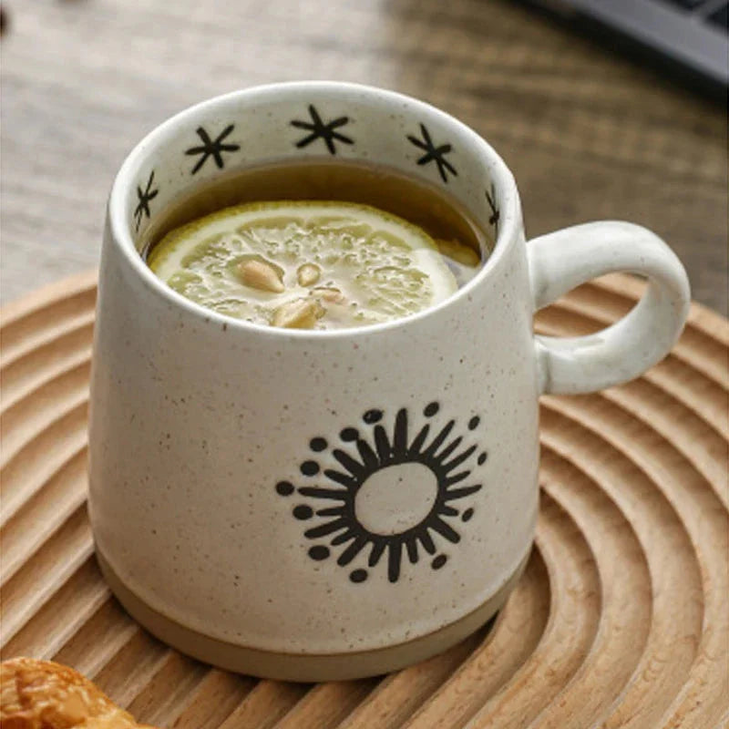 Handcrafted Japanese-inspired ceramic coffee mug with unique floral or sun design