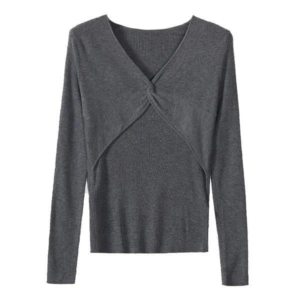 A stylish V-Neck jumper in dark grey, featuring a unique criss-cross design and a flattering slim fit for the modern Kiwi woman.