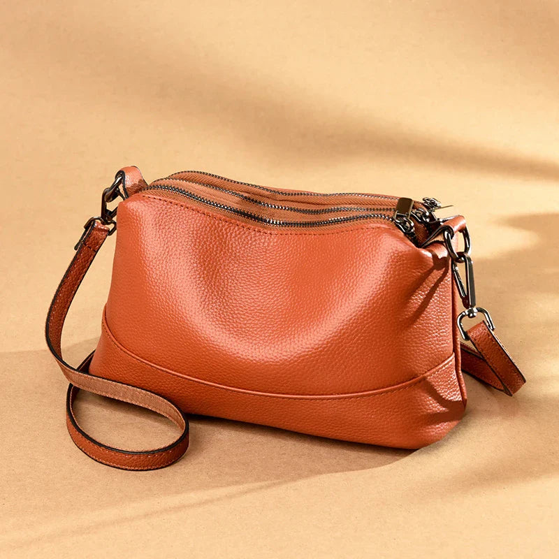 Premium cowhide shoulder bag in a variety of colors, featuring a stylish urban-inspired design, roomy main compartment, and adjustable strap for Kiwi women.