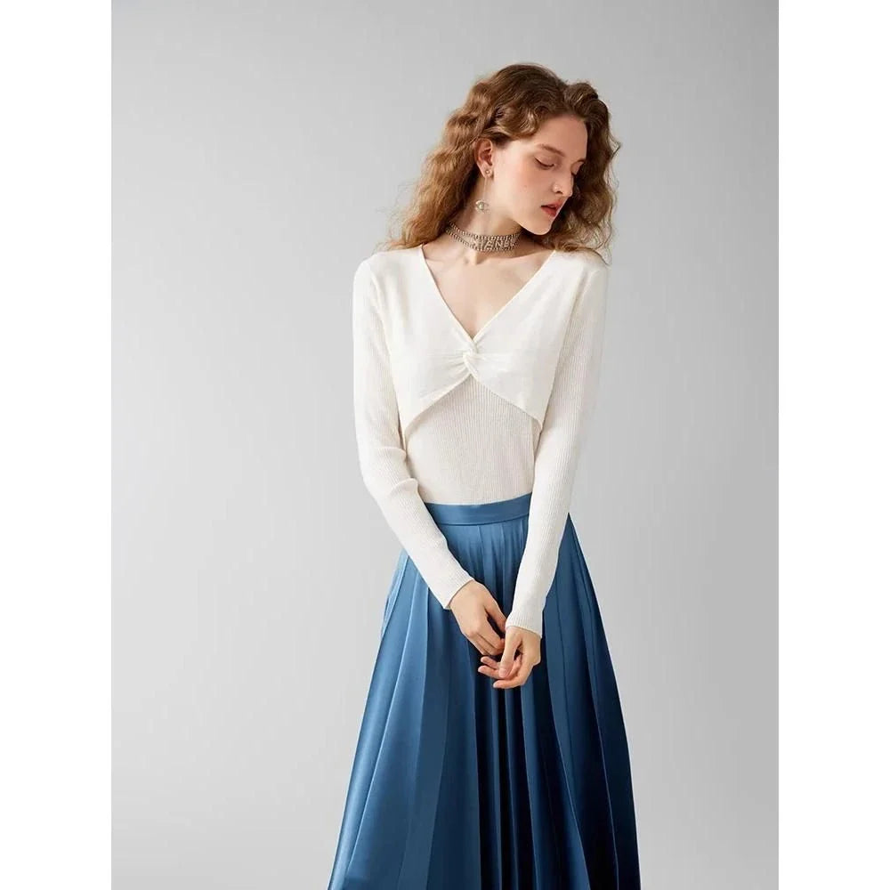 A stylish V-Neck jumper in dark grey, featuring a unique criss-cross design and a flattering slim fit for the modern Kiwi woman.