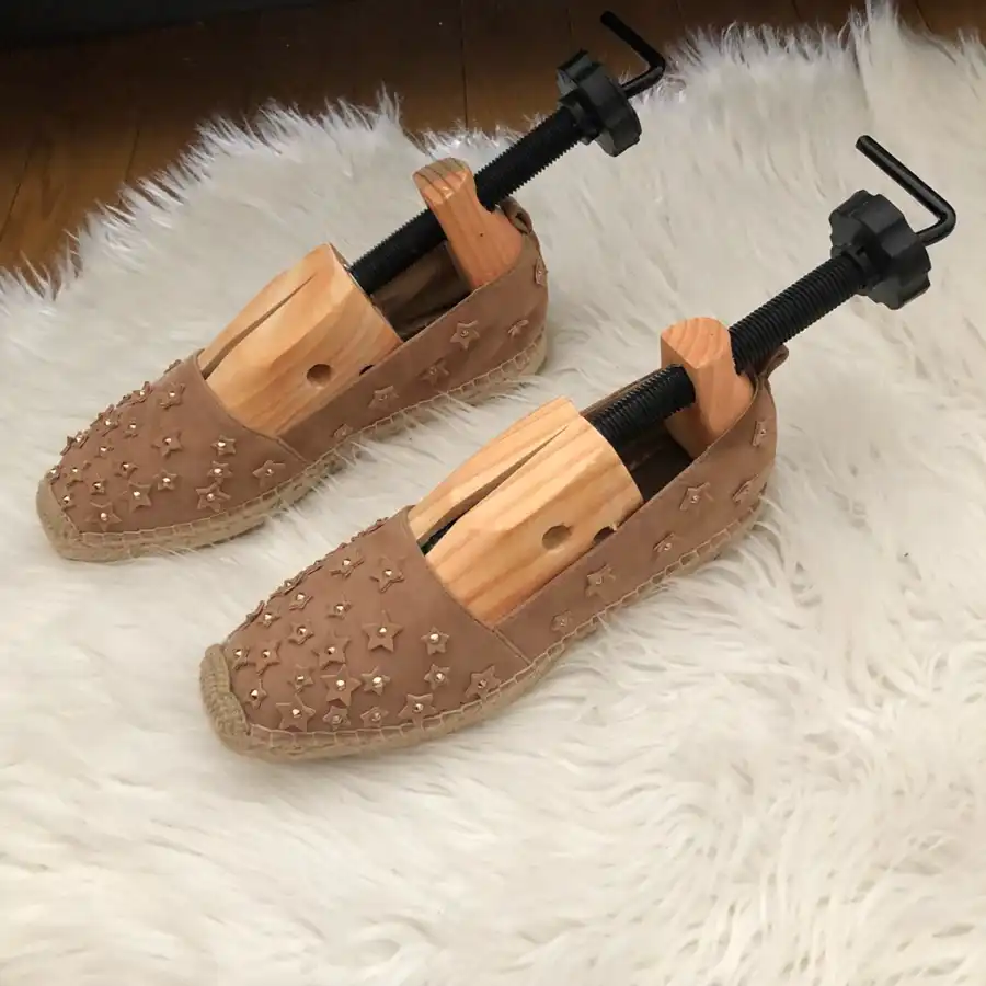 Adjustable wooden shoe stretcher expanding a pair of shoes, made with high-quality New Zealand timber