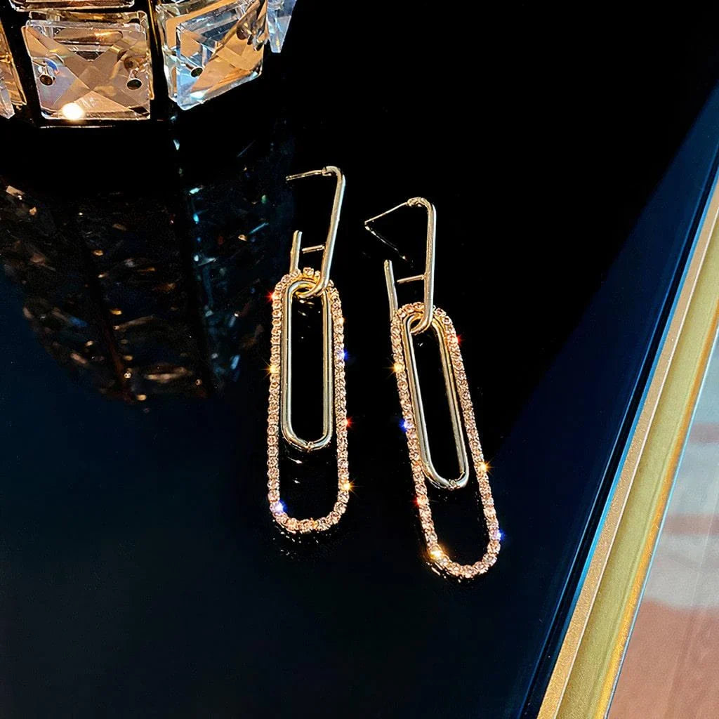 Elegant oblong gold earrings with sparkling rhinestones, a modern and glamorous accessory