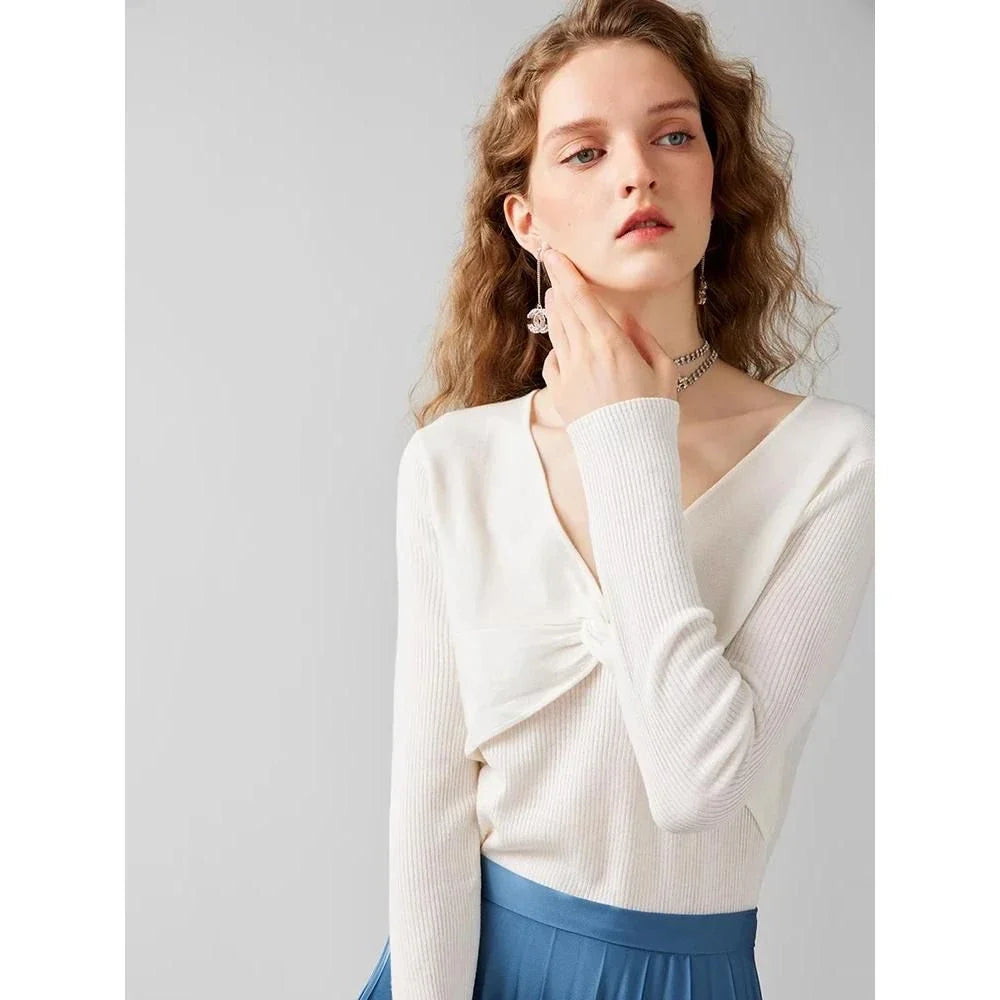 A stylish V-Neck jumper in dark grey, featuring a unique criss-cross design and a flattering slim fit for the modern Kiwi woman.