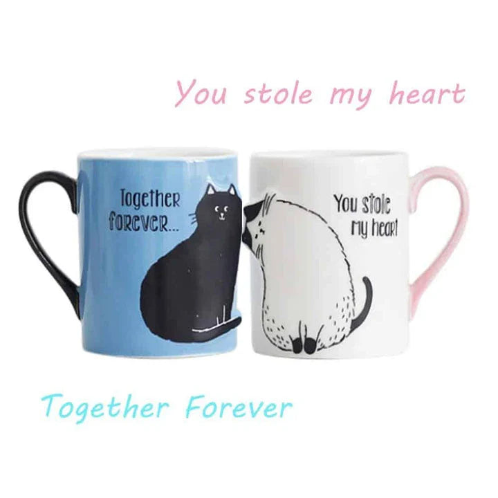 Two ceramic mugs with a playful design of two cats kissing, perfect for Kiwi cat lovers and couples