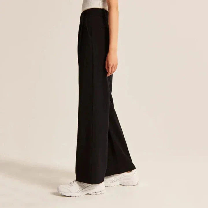 Elegant high-waisted wide-leg trousers in a gray-blue color, perfect for the modern woman's wardrobe.