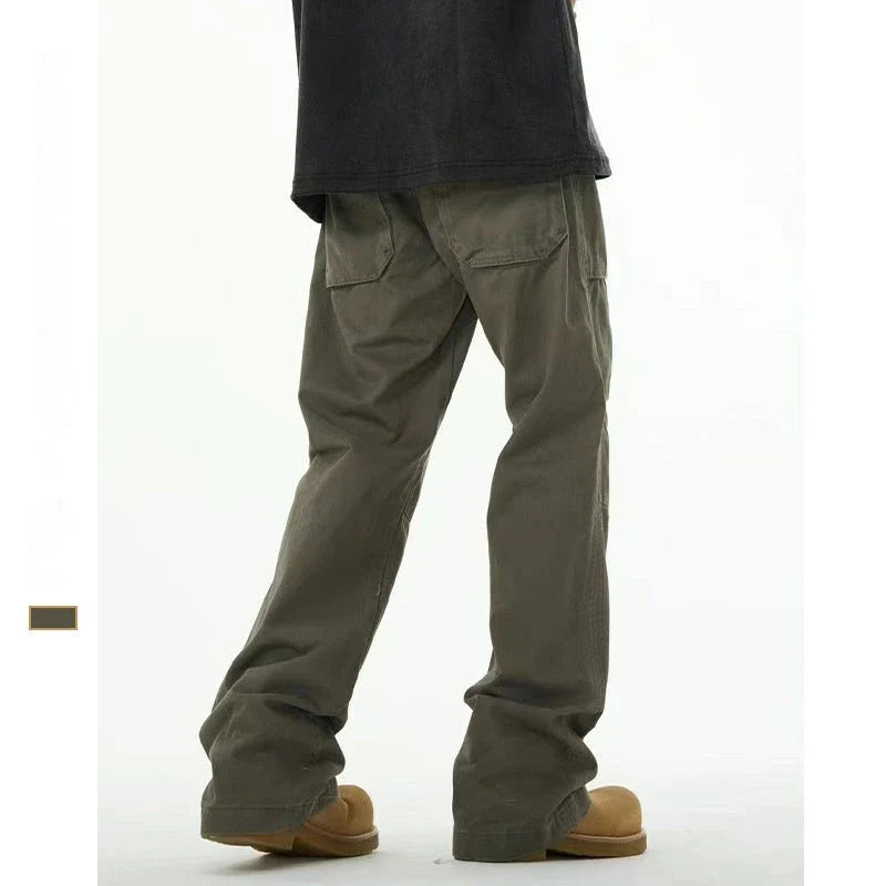 A pair of grey-green cotton overalls with a straight-leg design, perfect for the laid-back Kiwi lifestyle.