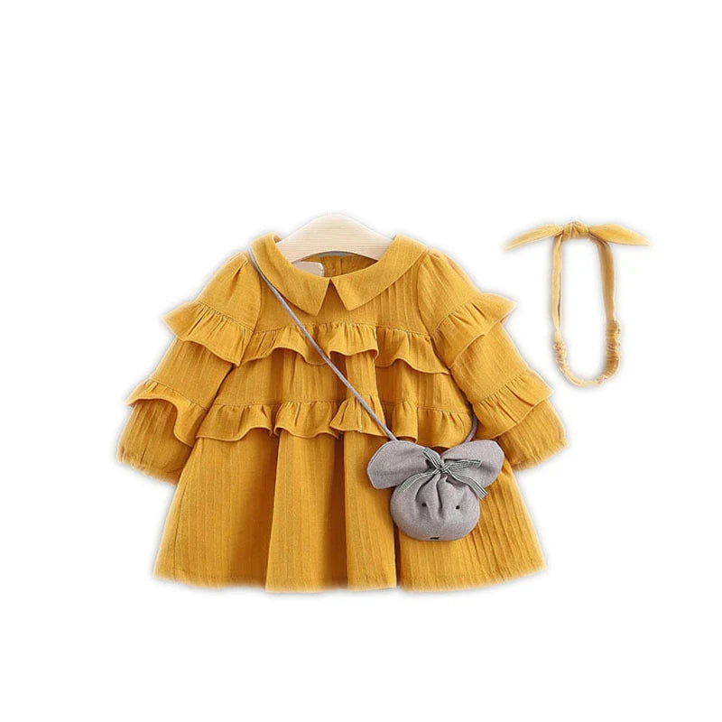 A beautiful baby girl summer dress with a princess silhouette, accessorized with a matching bag and hairband.