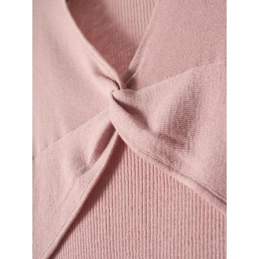 A stylish V-Neck jumper in dark grey, featuring a unique criss-cross design and a flattering slim fit for the modern Kiwi woman.