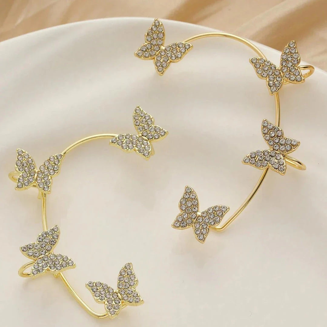 Pair of crystal butterfly clip-on earrings with pearl beads and tassels, in gold color