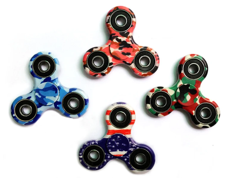 A premium designer spinner in various colors, designed to provide stress relief and improve focus for Kiwis