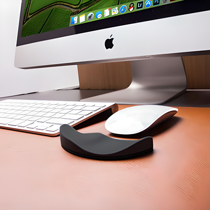 A white ergonomic wrist support pillow with silicon material on a modern desk, designed to provide comfort and natural alignment for computer users.