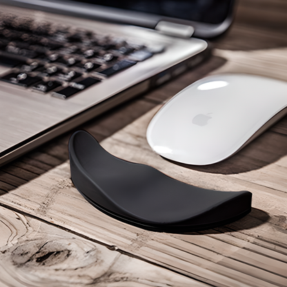 A white ergonomic wrist support pillow with silicon material on a modern desk, designed to provide comfort and natural alignment for computer users.