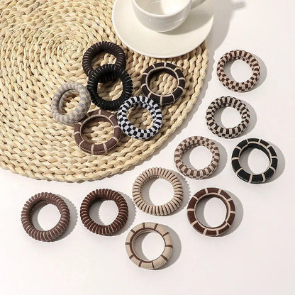 Stylish knitted lattice hair scrunchies in a black and white striped pattern, perfect for Kiwi women's hair accessories