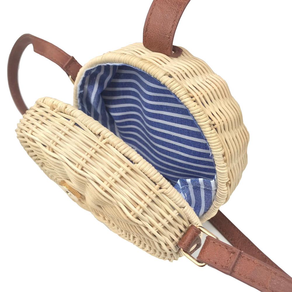 A collection of hand-woven tropical straw purses in various shapes, sizes, and designs, perfect for Kiwi summer style.