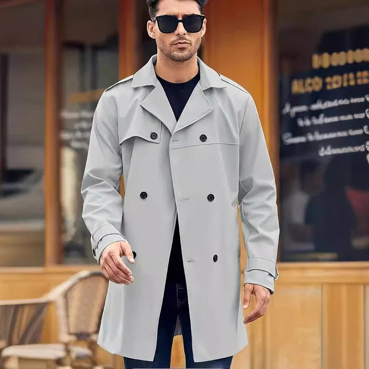 A classic double-breasted wool coat in light gray, designed and made in New Zealand for warmth and style.