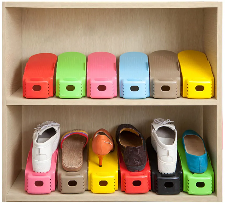 A pair of Twin-Stand™ Shoe Racks in various colours, holding multiple pairs of shoes in a compact, stacked design.