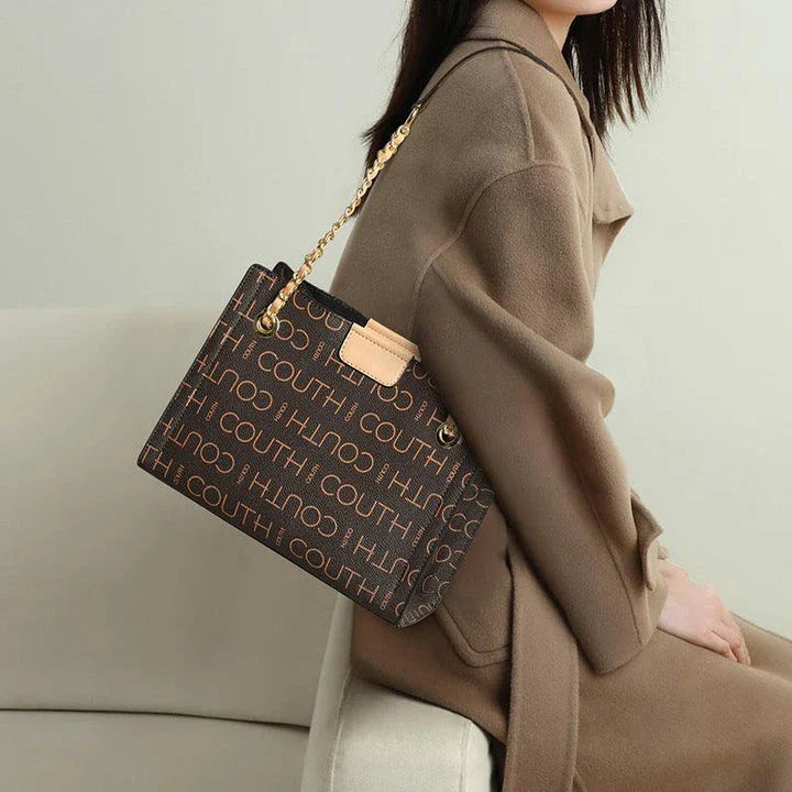 A stylish and roomy one-shoulder tote bag in apricot color, perfect for Kiwi fashionistas during the autumn and winter seasons.