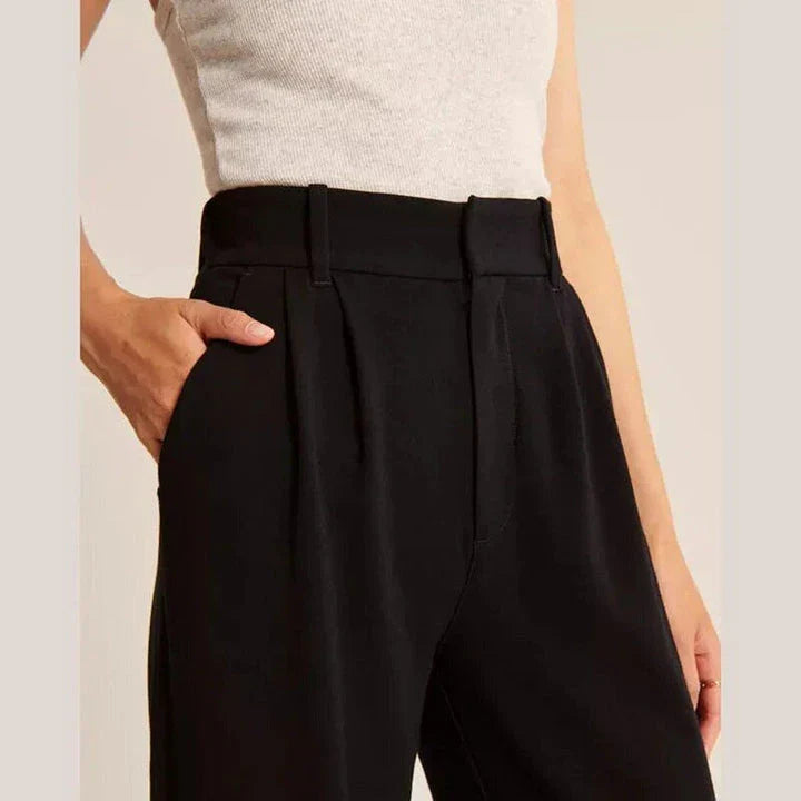 Elegant high-waisted wide-leg trousers in a gray-blue color, perfect for the modern woman's wardrobe.