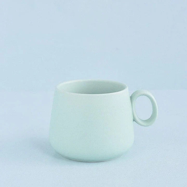 Pastel green ceramic coffee mug with a Kiwiana-inspired design, perfect for daily use in New Zealand homes and cafes.