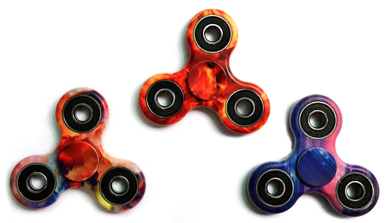 A premium designer spinner in various colors, designed to provide stress relief and improve focus for Kiwis