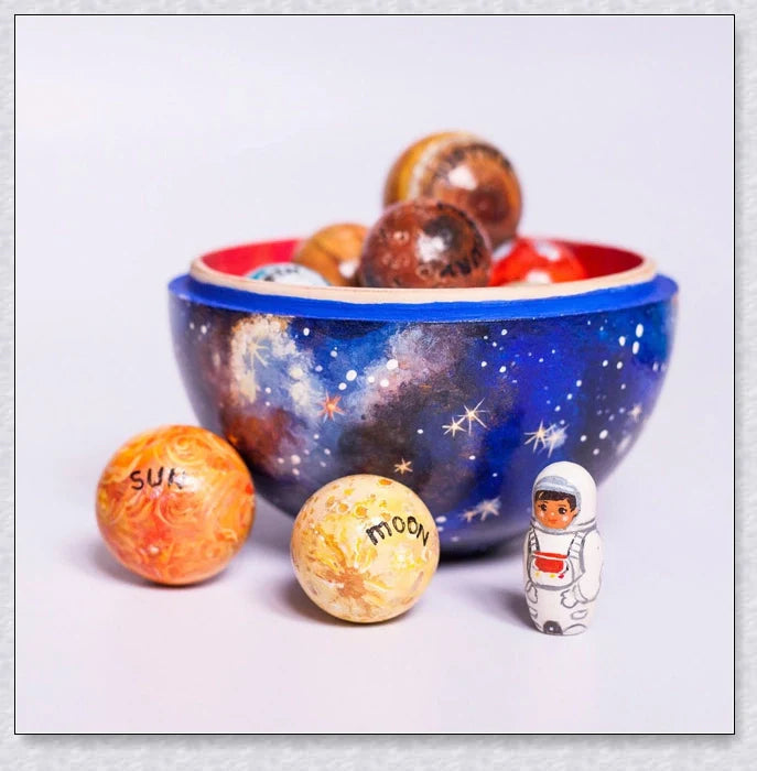 Wooden Solar System Learning Toy with hand-painted planets, sun, moon, rocket, and astronaut figures