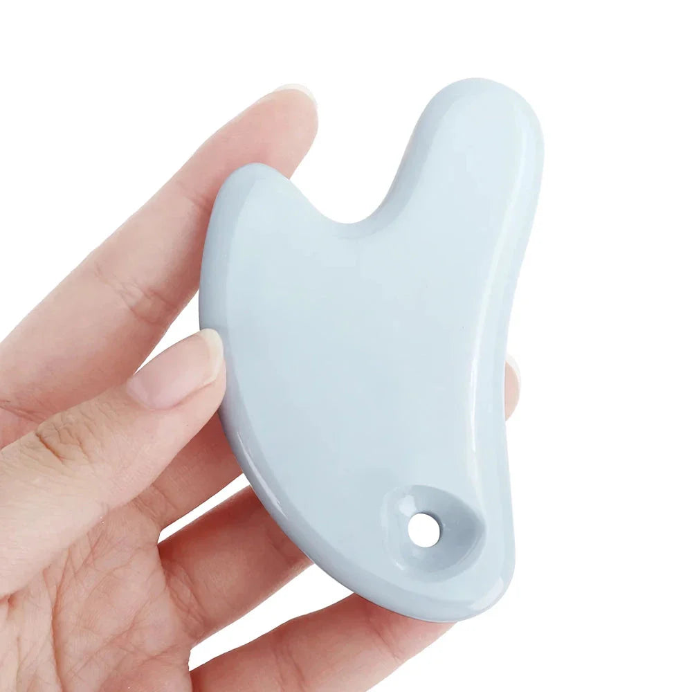 Ceramic Gua Sha Face Massager in various colors - Pink, Blue, and White - for skin rejuvenation and relaxation