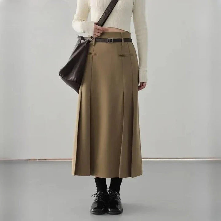 Elegant high-waisted pleated a-line skirt in a classic solid color for versatile wear throughout the autumn and winter seasons.