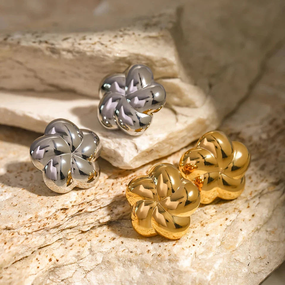 18k gold plated stainless steel flower shaped stud earrings in a silver color