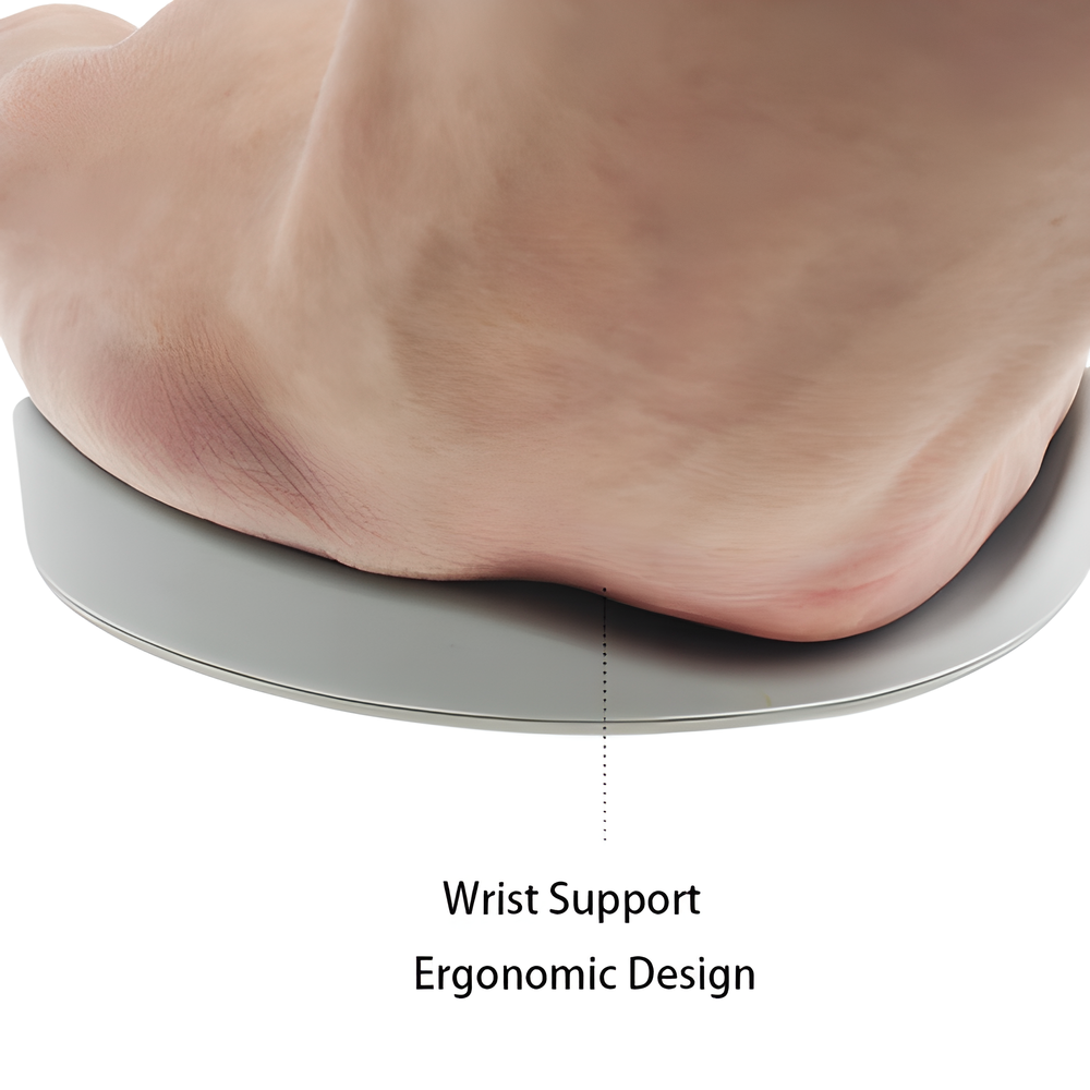 A white ergonomic wrist support pillow with silicon material on a modern desk, designed to provide comfort and natural alignment for computer users.