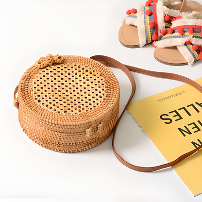 A collection of hand-woven tropical straw purses in various shapes, sizes, and designs, perfect for Kiwi summer style.