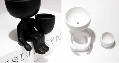 Stylish ceramic planter in black or white, featuring a unique humanoid design perfect for growing indoor plants