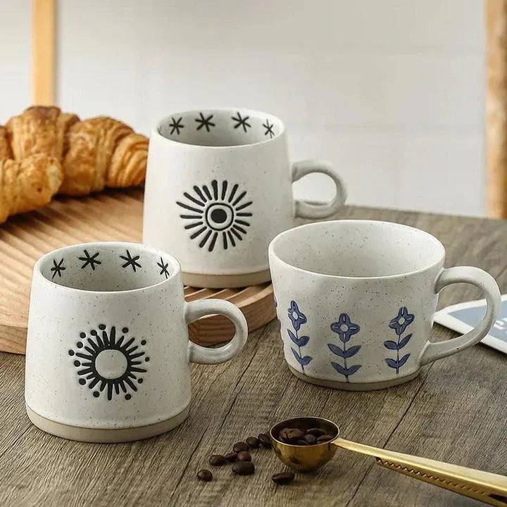 Handcrafted Japanese-inspired ceramic coffee mug with unique floral or sun design