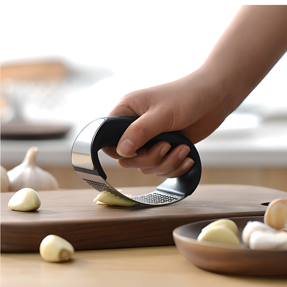 Stainless steel garlic mincer with ergonomic rocking design for quick and easy garlic preparation