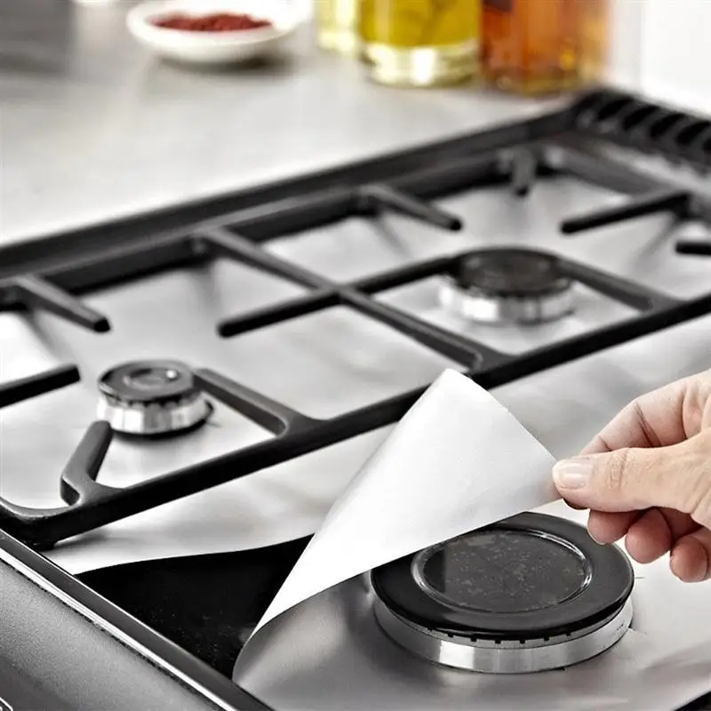 Four reusable, adjustable silicone stove top protective covers in silver and black colours