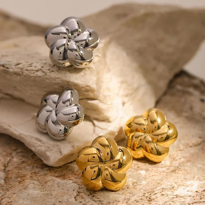 18k gold plated stainless steel flower shaped stud earrings in a silver color