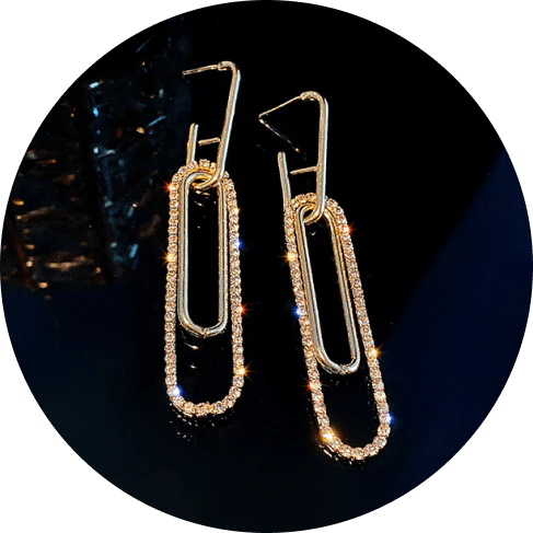 Elegant oblong gold earrings with sparkling rhinestones, a modern and glamorous accessory