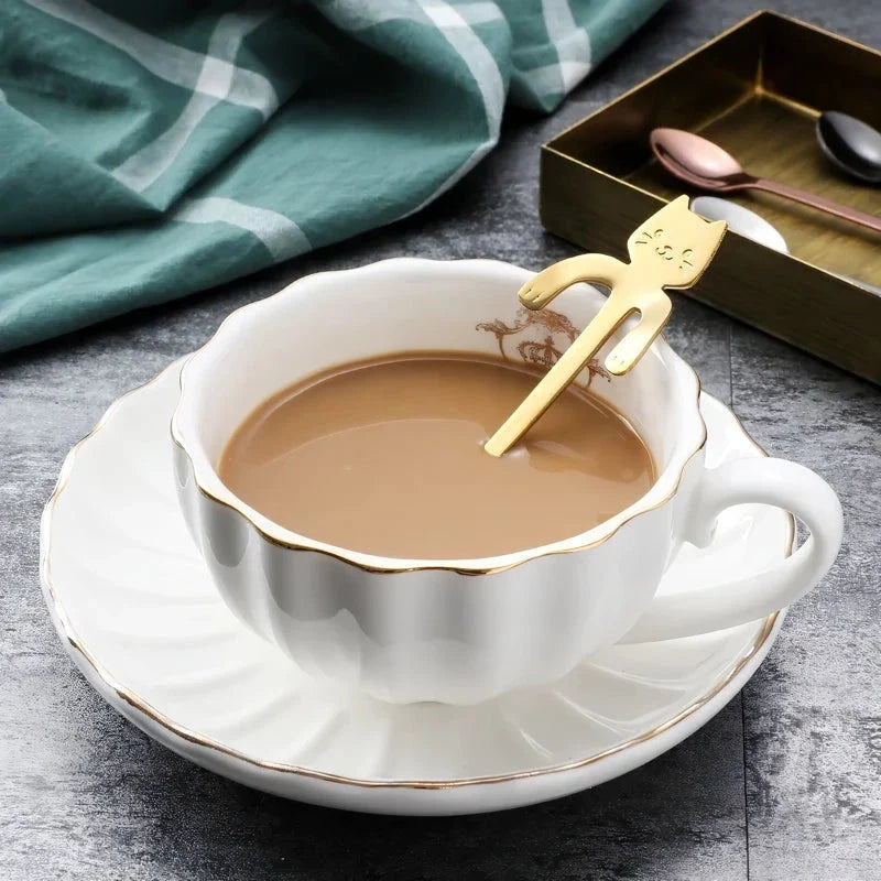 A charming cat-shaped stainless steel teaspoon with a sleek, gold finish, perfect for Kiwi tea and coffee drinkers.